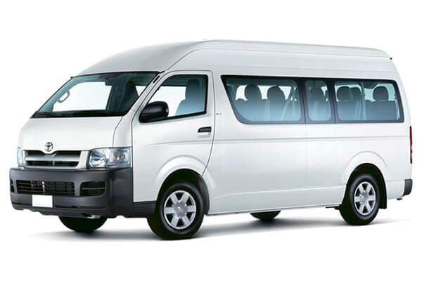 White Toyota HiAce 12-Seater Minibus.