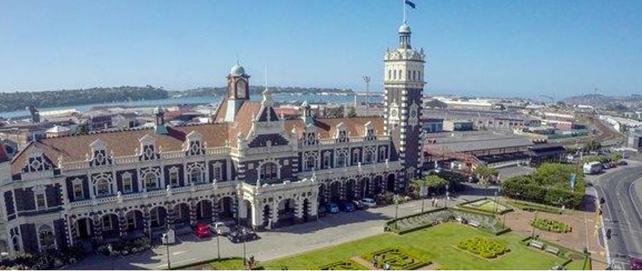 Beautiful day in with aerial view of Dunedin Railway Station in the background.