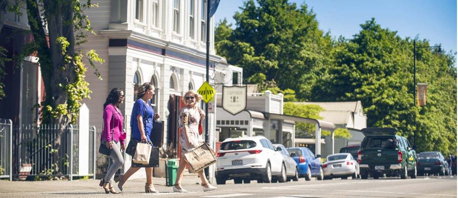 Three women outdoors on a sunny day, enjoying shopping at Greytown.