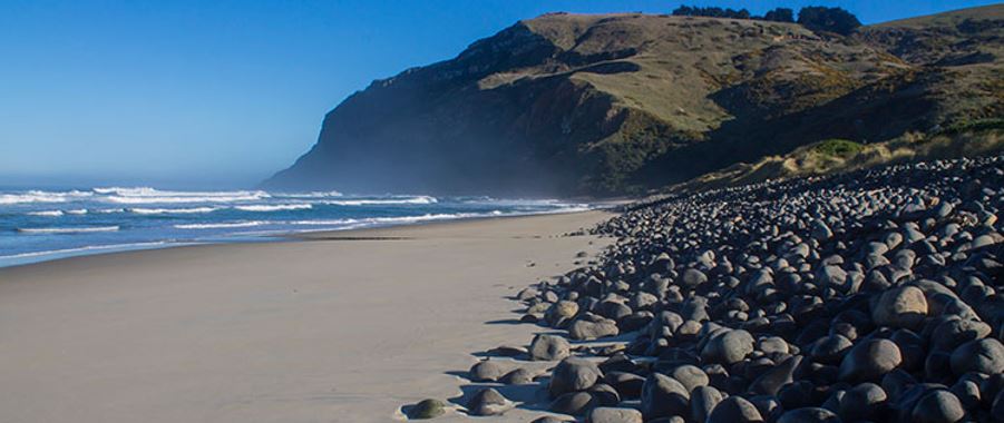 beach view of Boulder Beach with waves crashing.