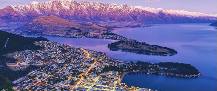 Amazing sunset view of Queenstown from the Skyline Gondola, with a mountainous backdrop.