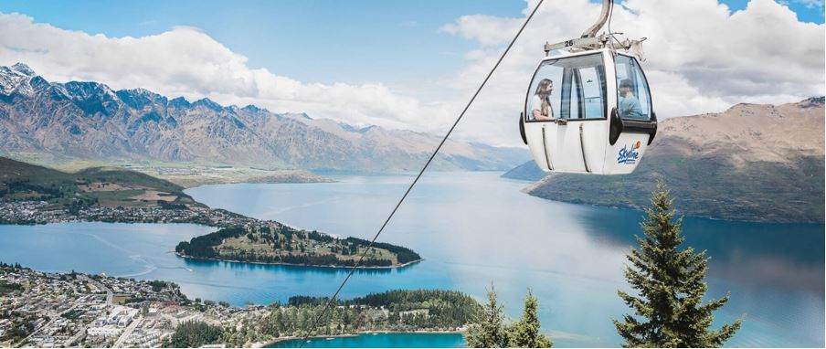 Gondola going up Bob's Peak overlooking Queenstown high above sea level.